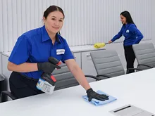 2 women cleaning tables