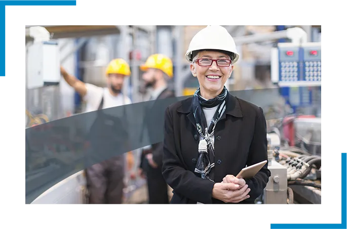 A smiling person working in an industrial facility